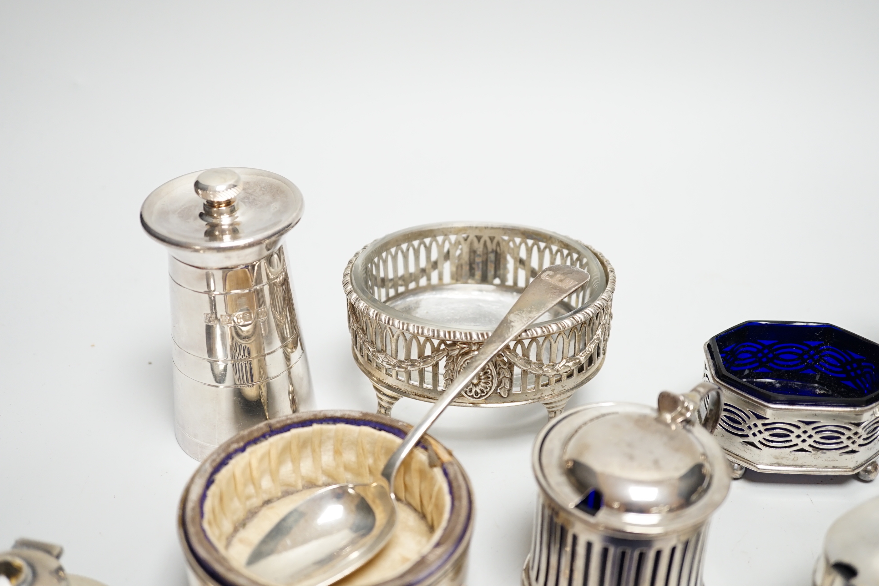 Eight assorted silver condiments, including a George III oval salt and four other items including small inkwell.